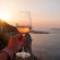Holding a glas of Santorini Wine overlooking the caldera