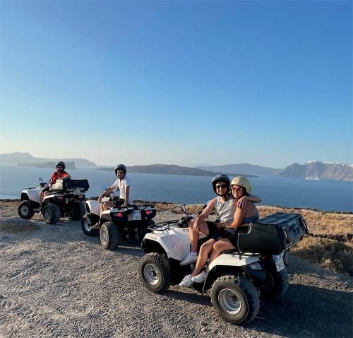 Group of friends on ATV tour in Santorini, overlooking the caldera.