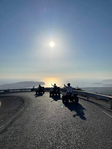 Friends on ATV Tour in Santorini driving along the caldera